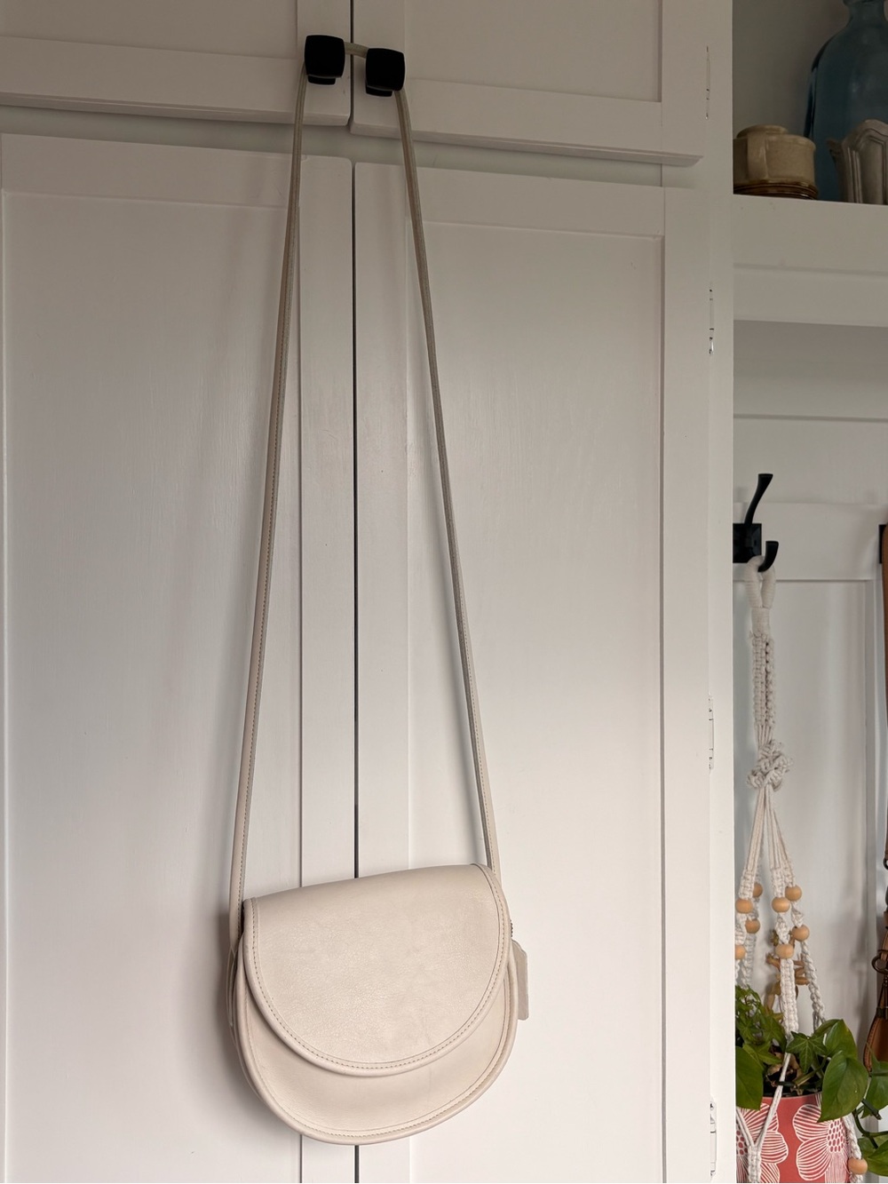 Vintage Coach Casey crossbody bag in a light ivory or bone-colored leather.